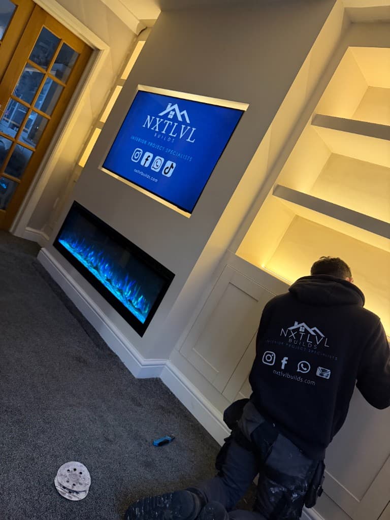 NxtlvlBuilds media wall with electric fireplace and built-in cabinetry