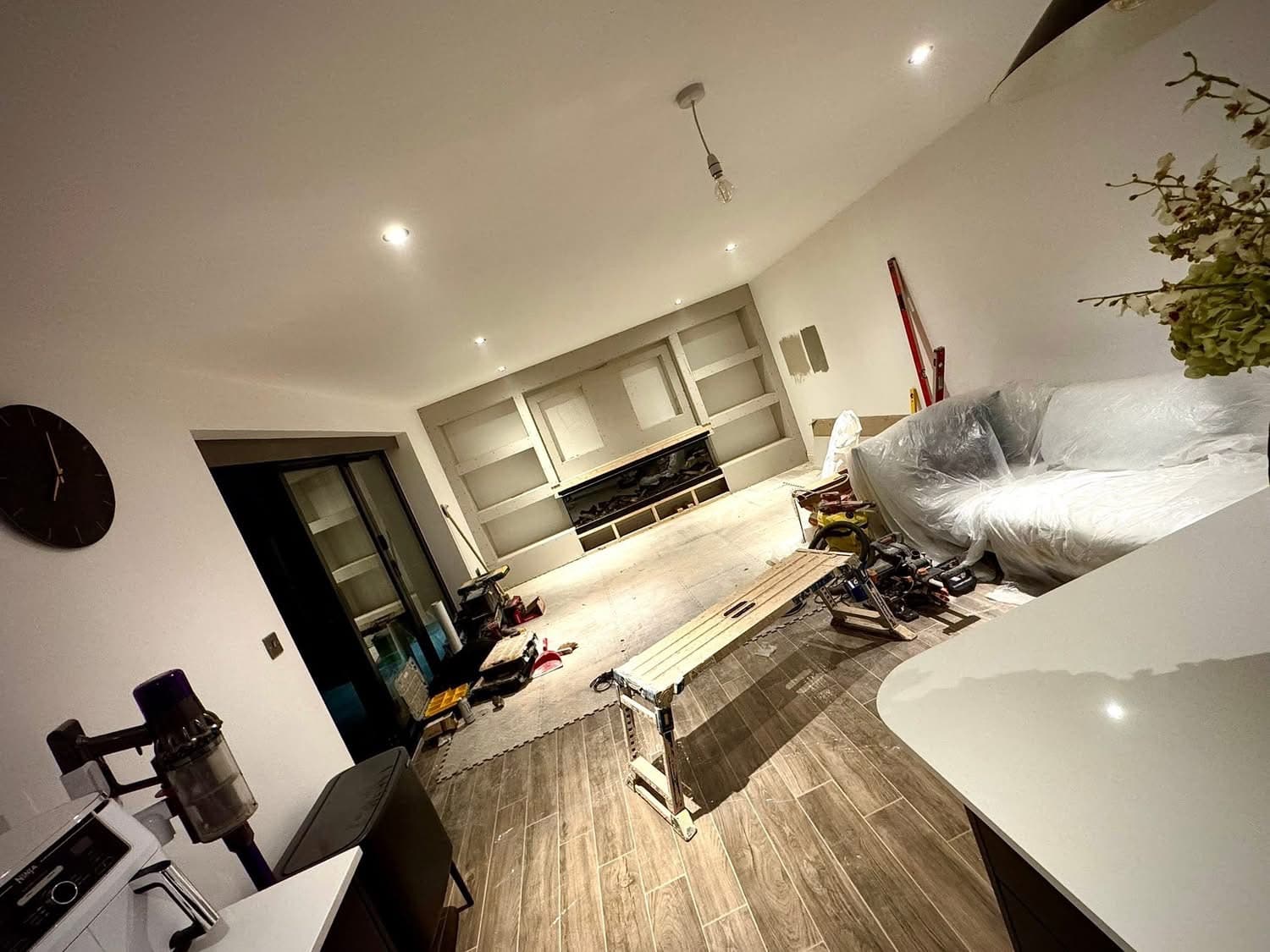 Media wall and flooring project in progress — built-in shelving and feature wall