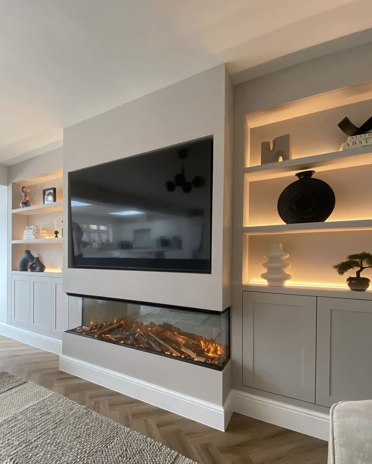 Bespoke media wall with integrated electric fire and built-in cabinetry - media wall installation